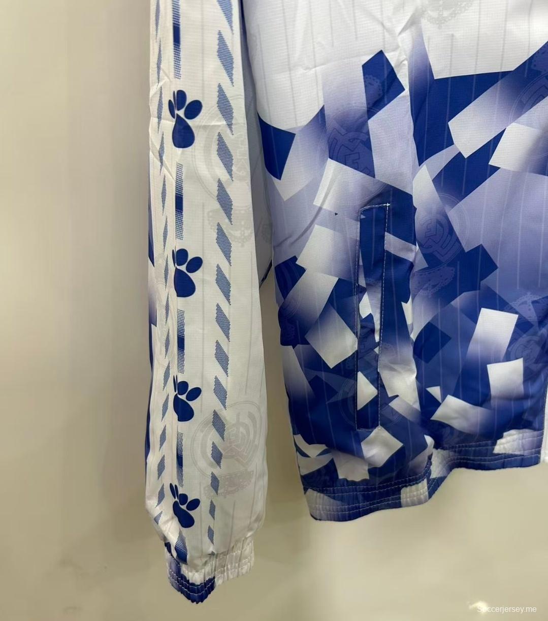 25/26 ريال مدريد سترة واقية من الريال أبيض بنقشة هندسية زرقاء