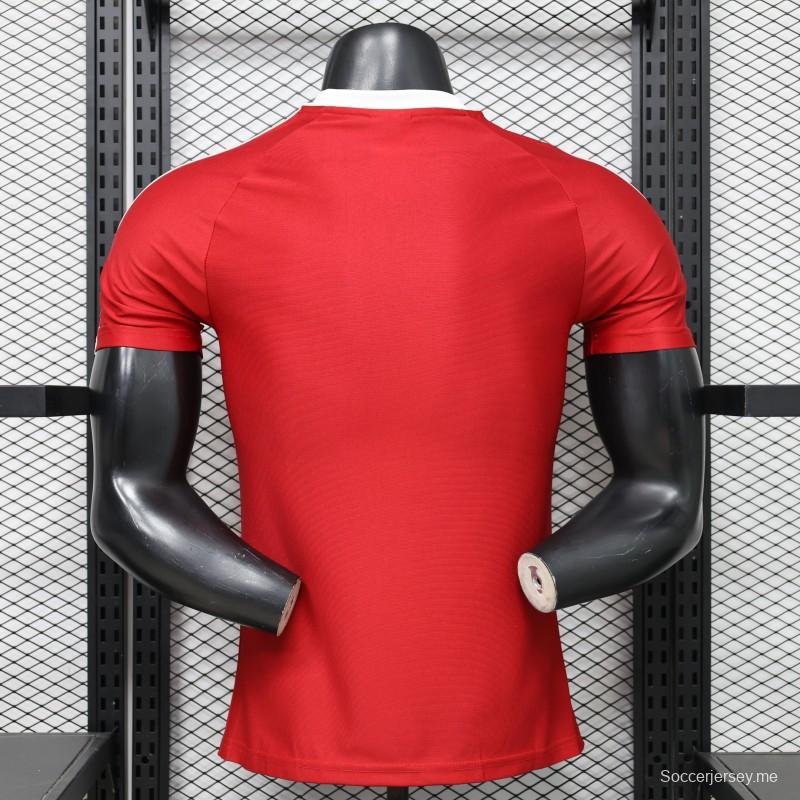 قميص لاعب مانشستر يونايتد باللون الأحمر مع ثلاث خطوط بيضاء على الكتفين - موسم 2026/2027